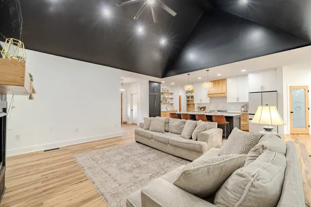 a kitchen with granite countertop white cabinets and stainless steel appliances