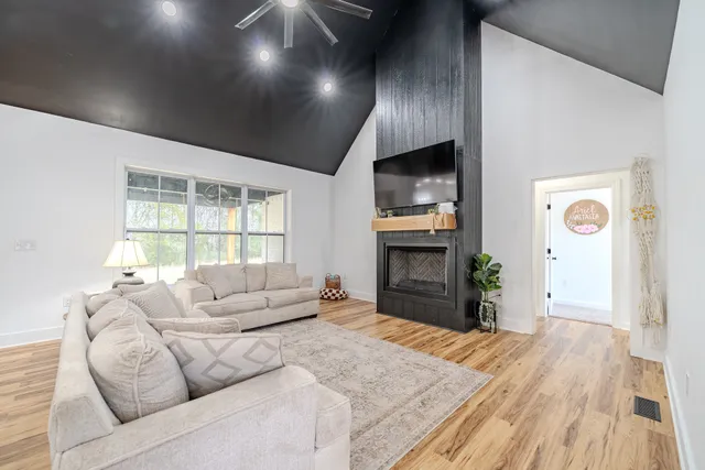 a kitchen with a stove oven and a view of living room