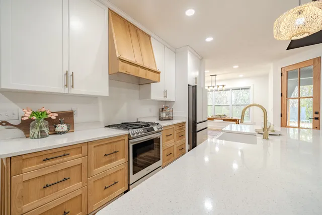 a kitchen with cabinets and wooden floor