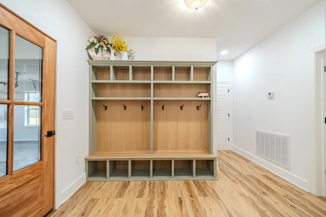 a bedroom with bed and wooden floor