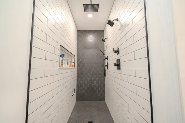 a bedroom with a large bed and a chandelier