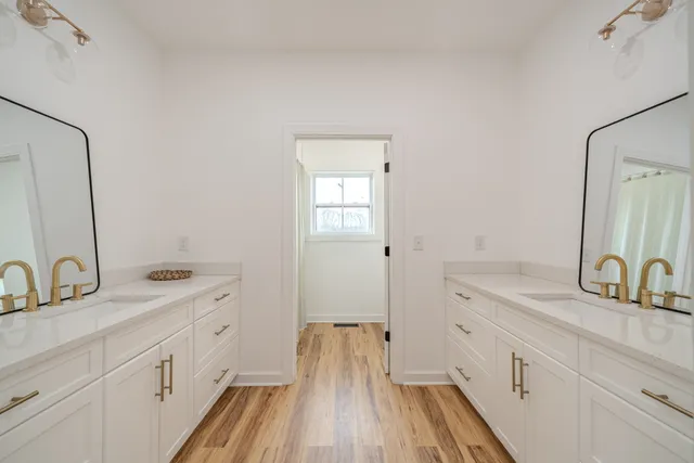 a view of a bedroom with wooden floor and closet