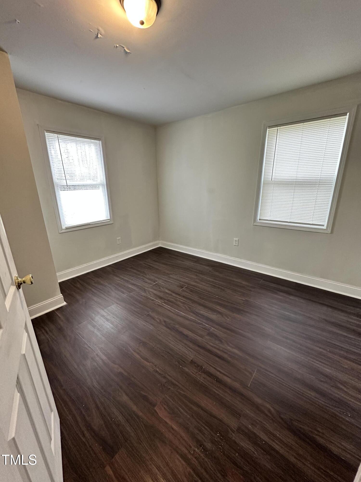 4989 Highway 217 Erwin, NC 28339 - Photo 13 of 14 an empty room with wooden floor and windows