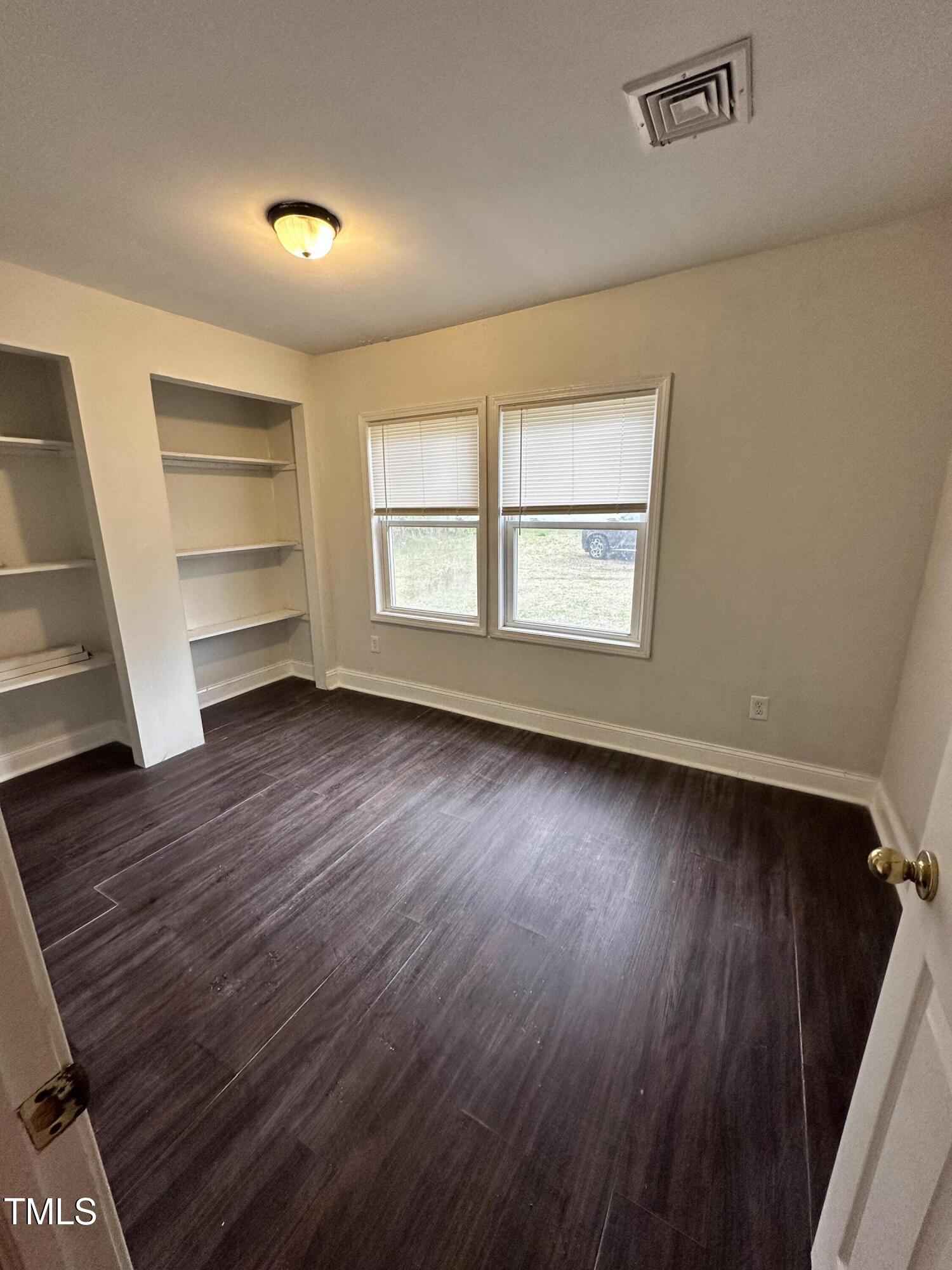 4989 Highway 217 Erwin, NC 28339 - Photo 14 of 14 wooden floor in an empty room with a window