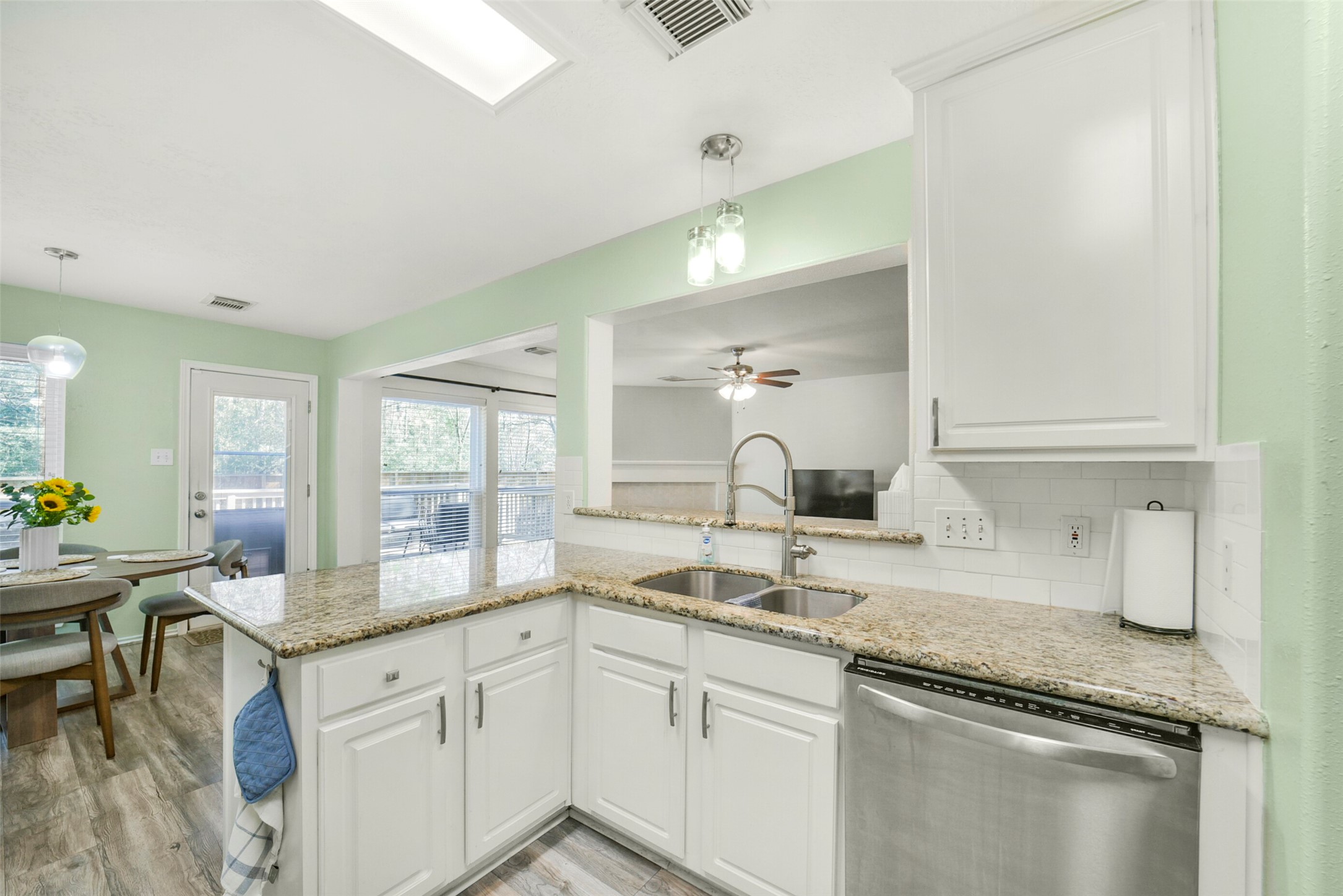 38 Tallow Hill Place Spring, TX 77382 - Photo 14 of 50 a kitchen with granite countertop a sink and white cabinets