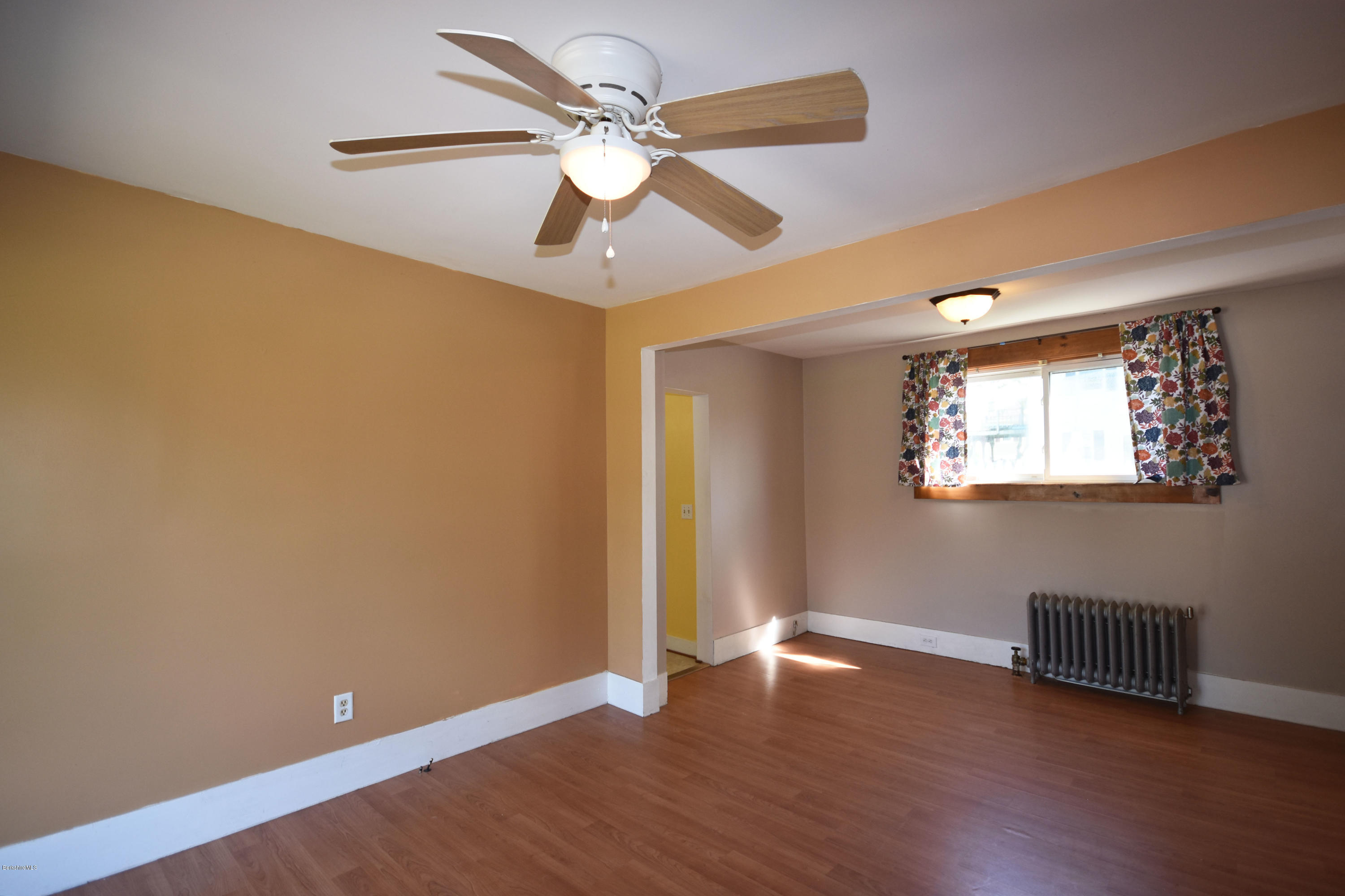 46 Berkley Street Pittsfield, MA 01201 - Photo 12 of 42 a view of an empty room with wooden floor and a ceiling fan