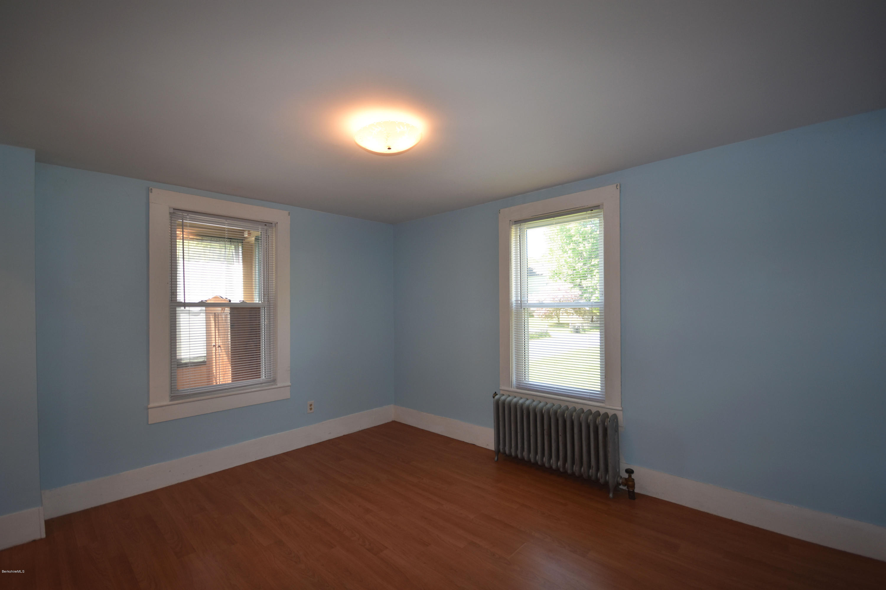 46 Berkley Street Pittsfield, MA 01201 - Photo 14 of 42 an empty room with wooden floor and windows