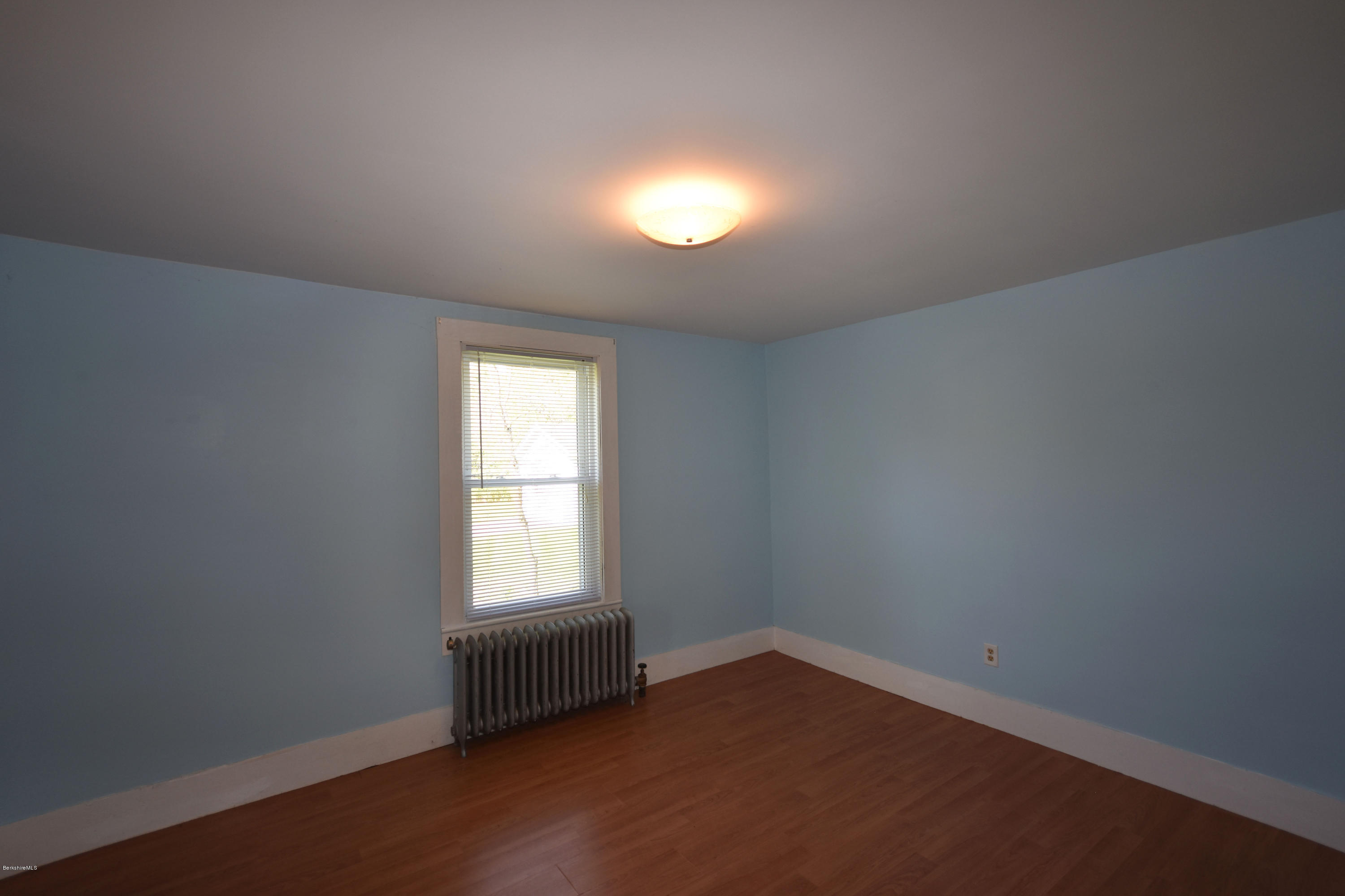 46 Berkley Street Pittsfield, MA 01201 - Photo 15 of 42 an empty room with wooden floor and windows