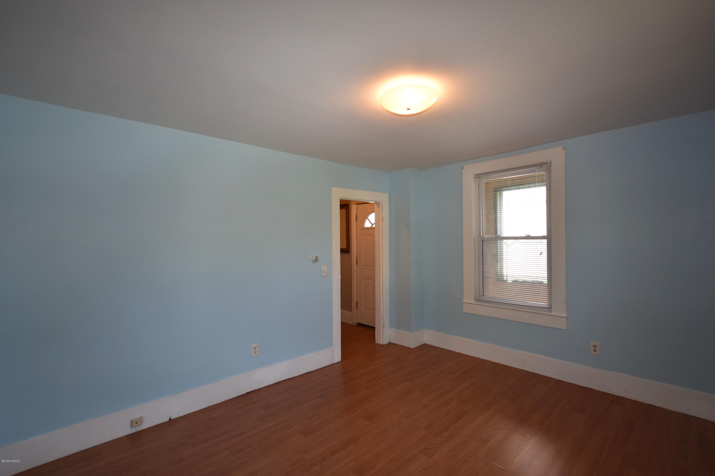 46 Berkley Street Pittsfield, MA 01201 - Photo 16 of 42 an empty room with wooden floor and windows