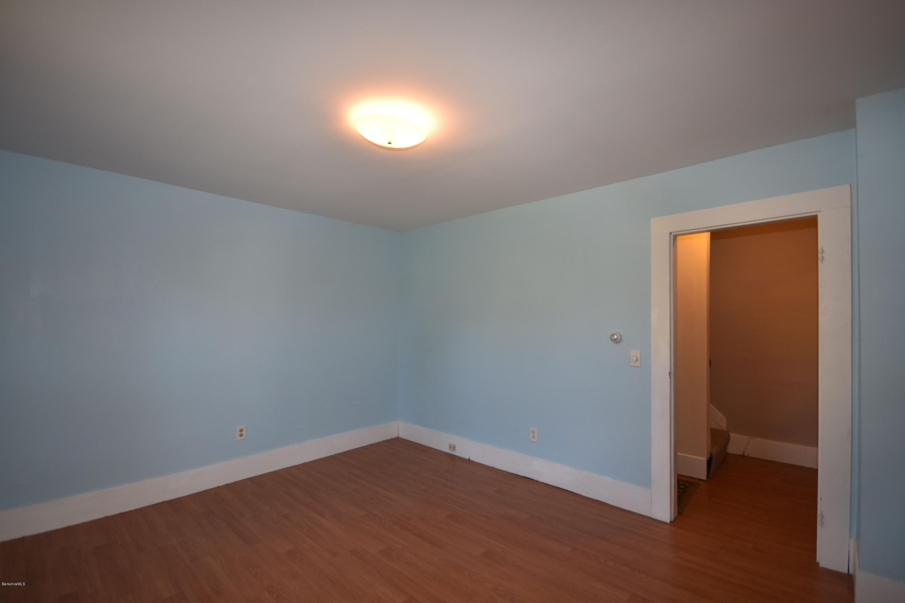 46 Berkley Street Pittsfield, MA 01201 - Photo 17 of 42 an empty room with wooden floor and windows