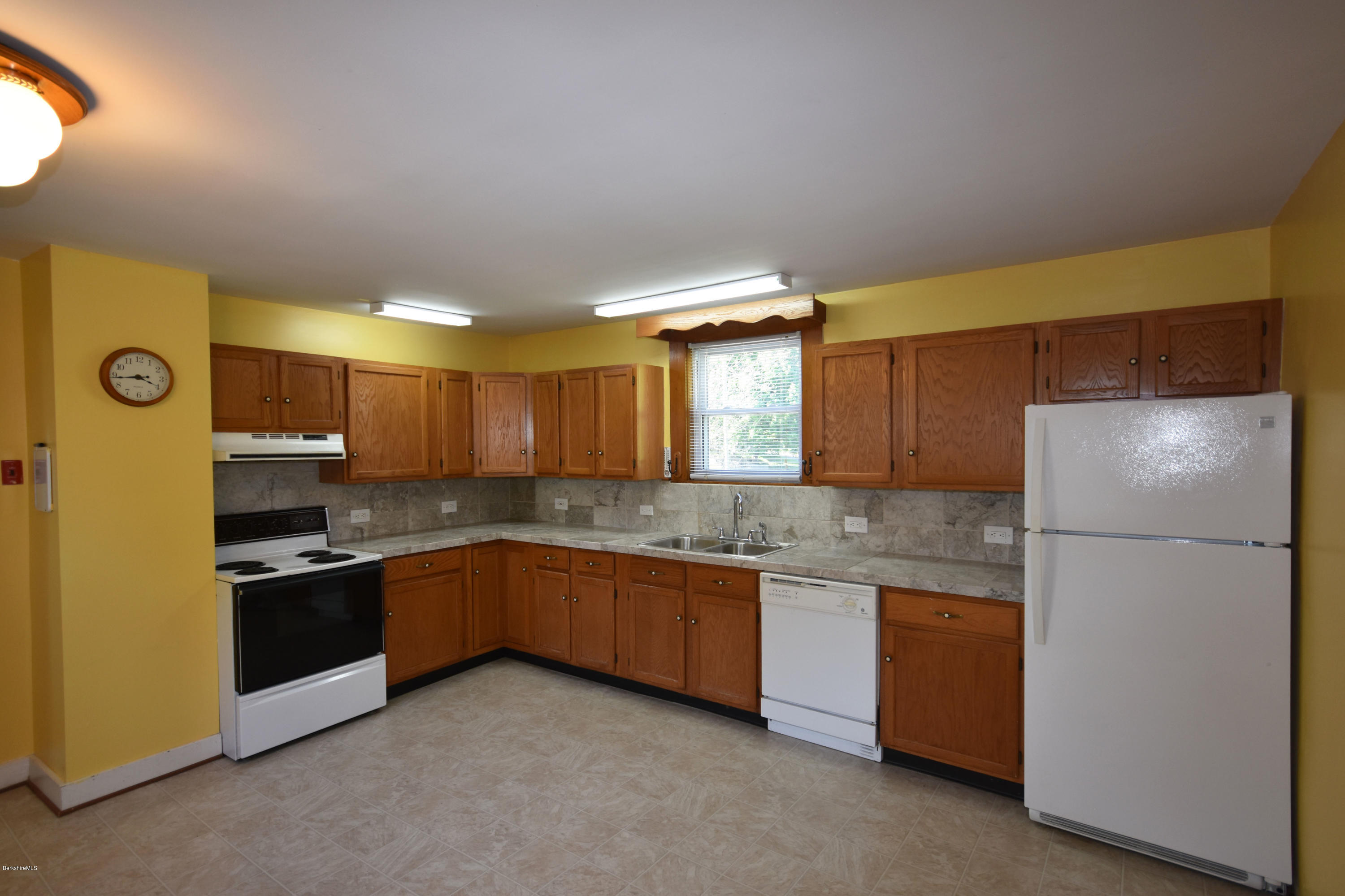 46 Berkley Street Pittsfield, MA 01201 - Photo 6 of 42 a kitchen with stainless steel appliances granite countertop a refrigerator and a sink