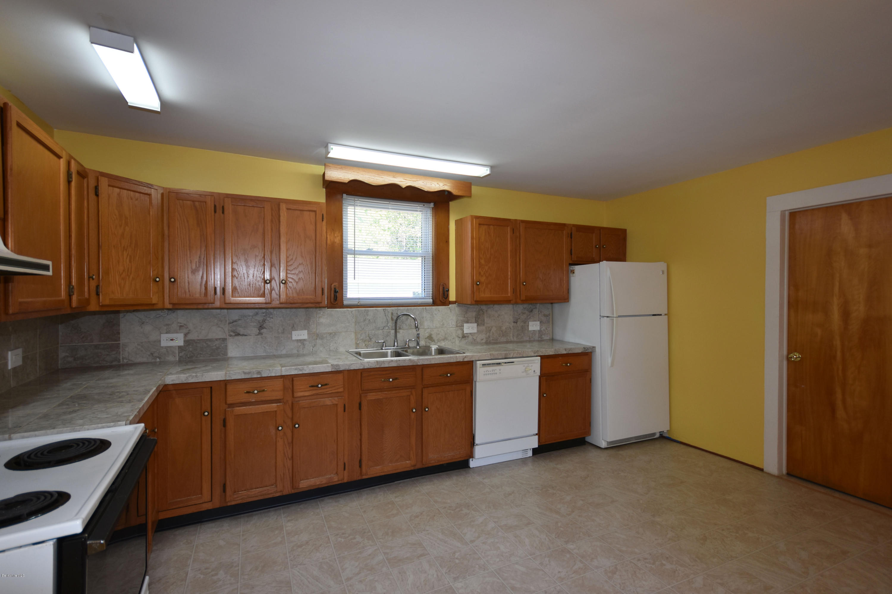 46 Berkley Street Pittsfield, MA 01201 - Photo 7 of 42 a kitchen that has a sink and a refrigerator in it