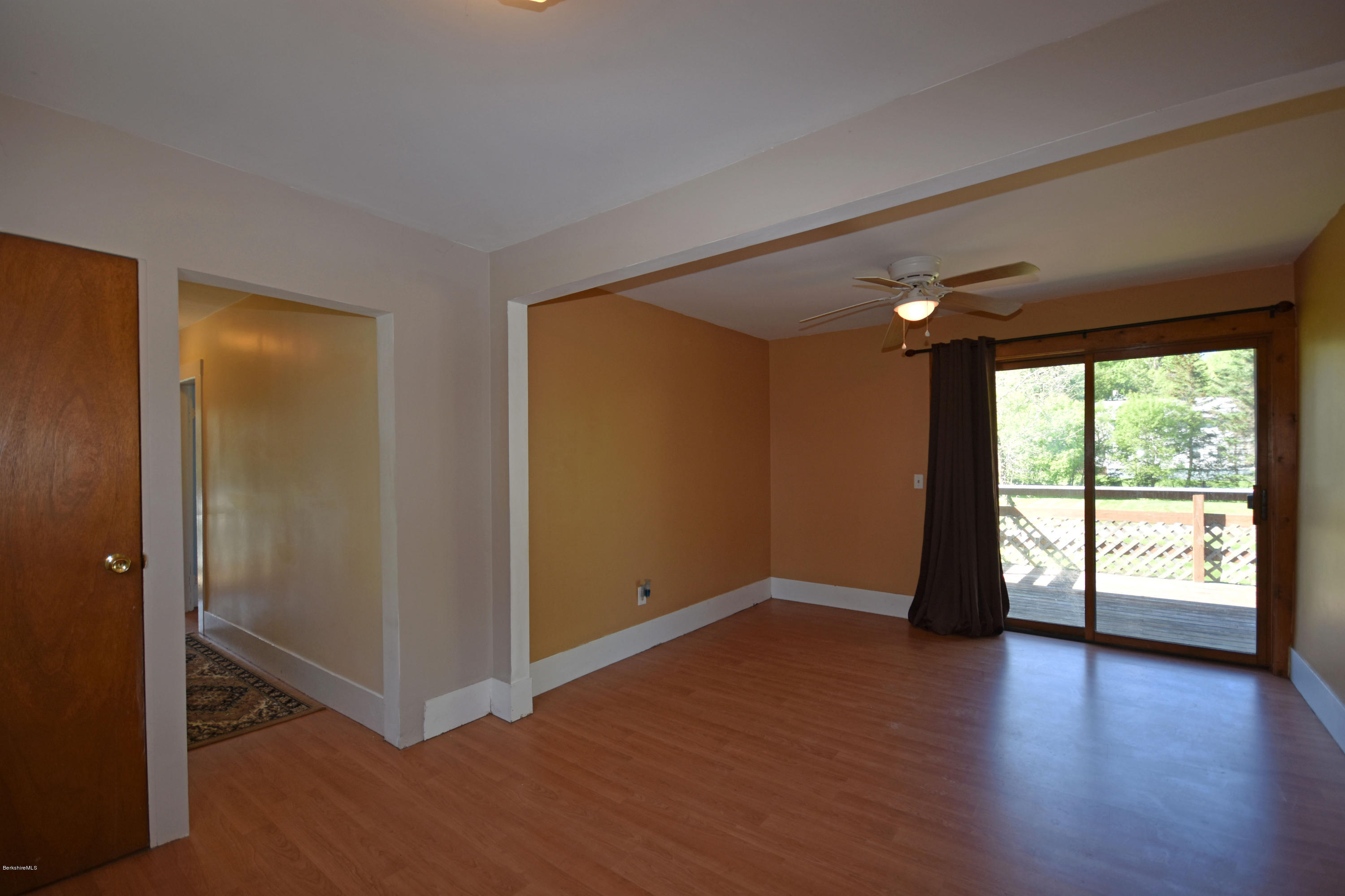 46 Berkley Street Pittsfield, MA 01201 - Photo 10 of 42 an empty room with wooden floor and windows with curtains