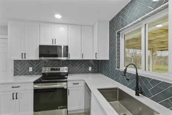 a kitchen with a stove and a sink