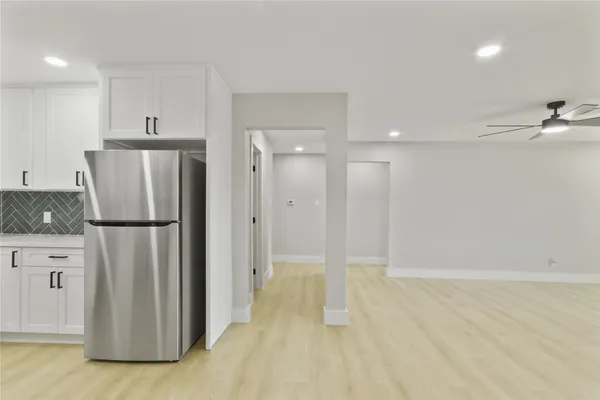 a view of a kitchen with a refrigerator a sink and a dishwasher