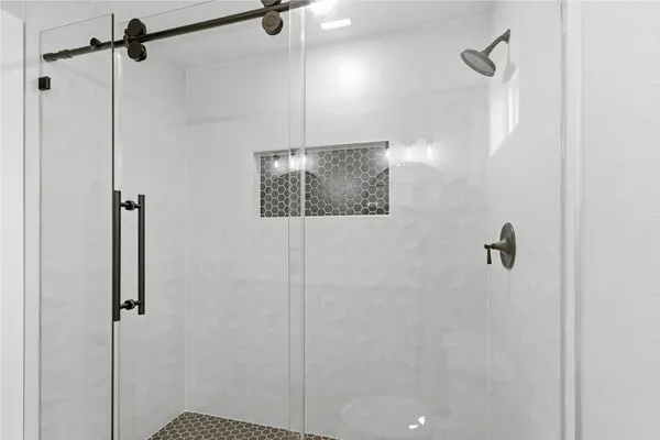 a bathroom with a shower and a shower