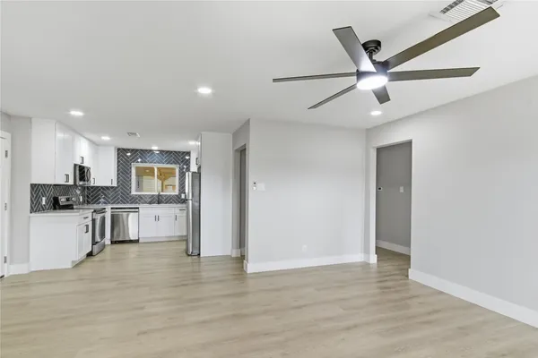 a view of a kitchen with a sink stainless steel appliances and cabinets