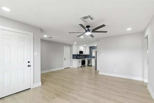 a view of kitchen with microwave and wooden floor