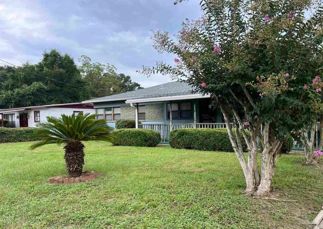 a front view of a house with garden