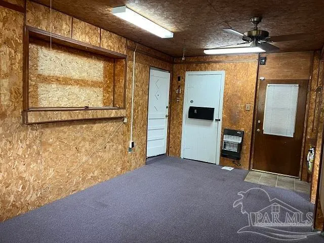 a view of a hallway with wooden floor and door