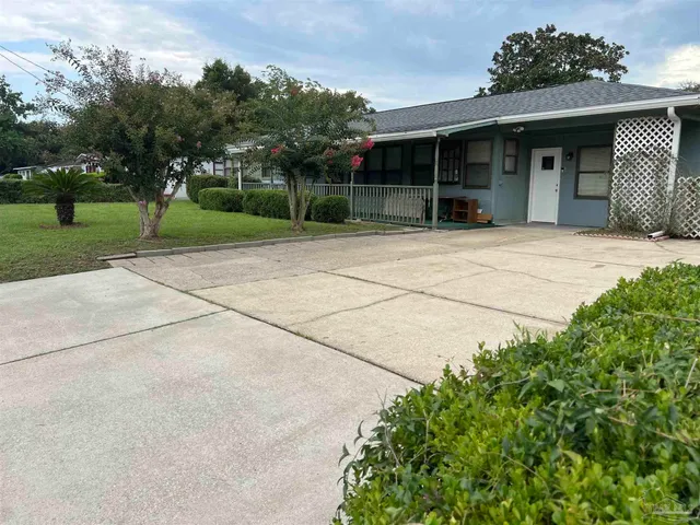 front view of a house with a garden