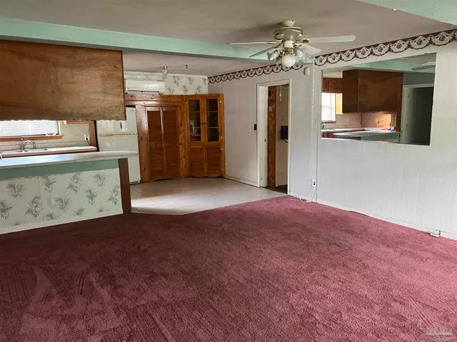 a view of a hallway with a kitchen