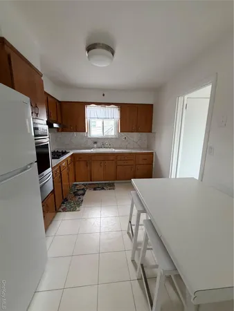 a kitchen with stainless steel appliances a stove a sink and a refrigerator