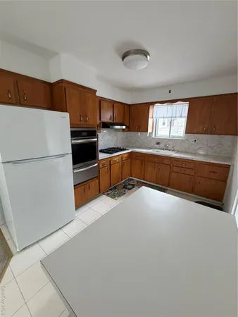 a kitchen with stainless steel appliances a refrigerator and a stove top oven