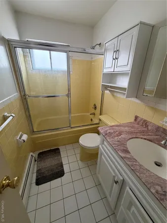a bathroom with a sink a toilet and mirror