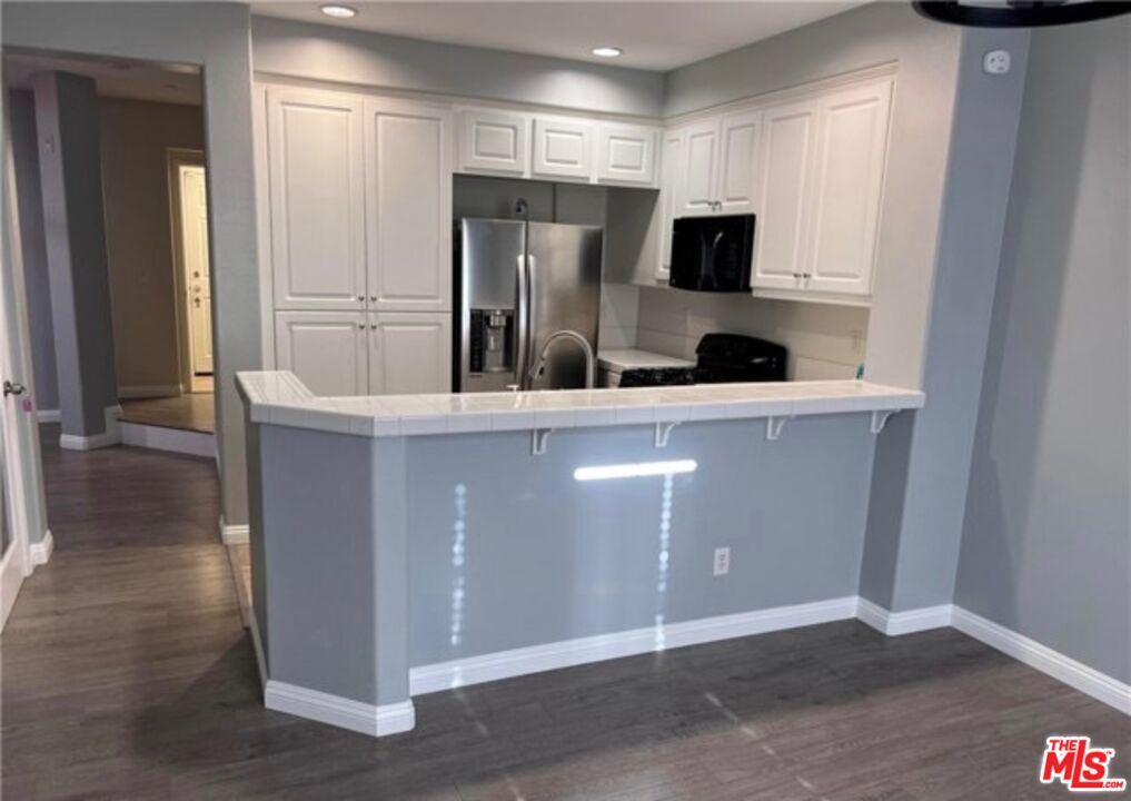 3944 Polk Street, Unit E Riverside, CA 92505 - Photo 5 of 21 a kitchen with stainless steel appliances a refrigerator and a stove