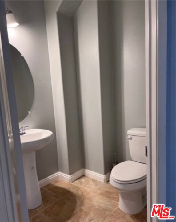 3944 Polk Street, Unit E Riverside, CA 92505 - Photo 6 of 21 a bathroom with a toilet and a sink