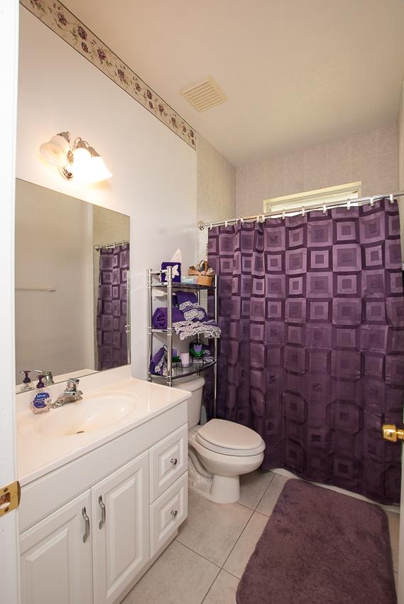 12557 154th Road North Jupiter, FL 33478 - Photo 21 of 38 a bathroom with a sink a toilet and shower