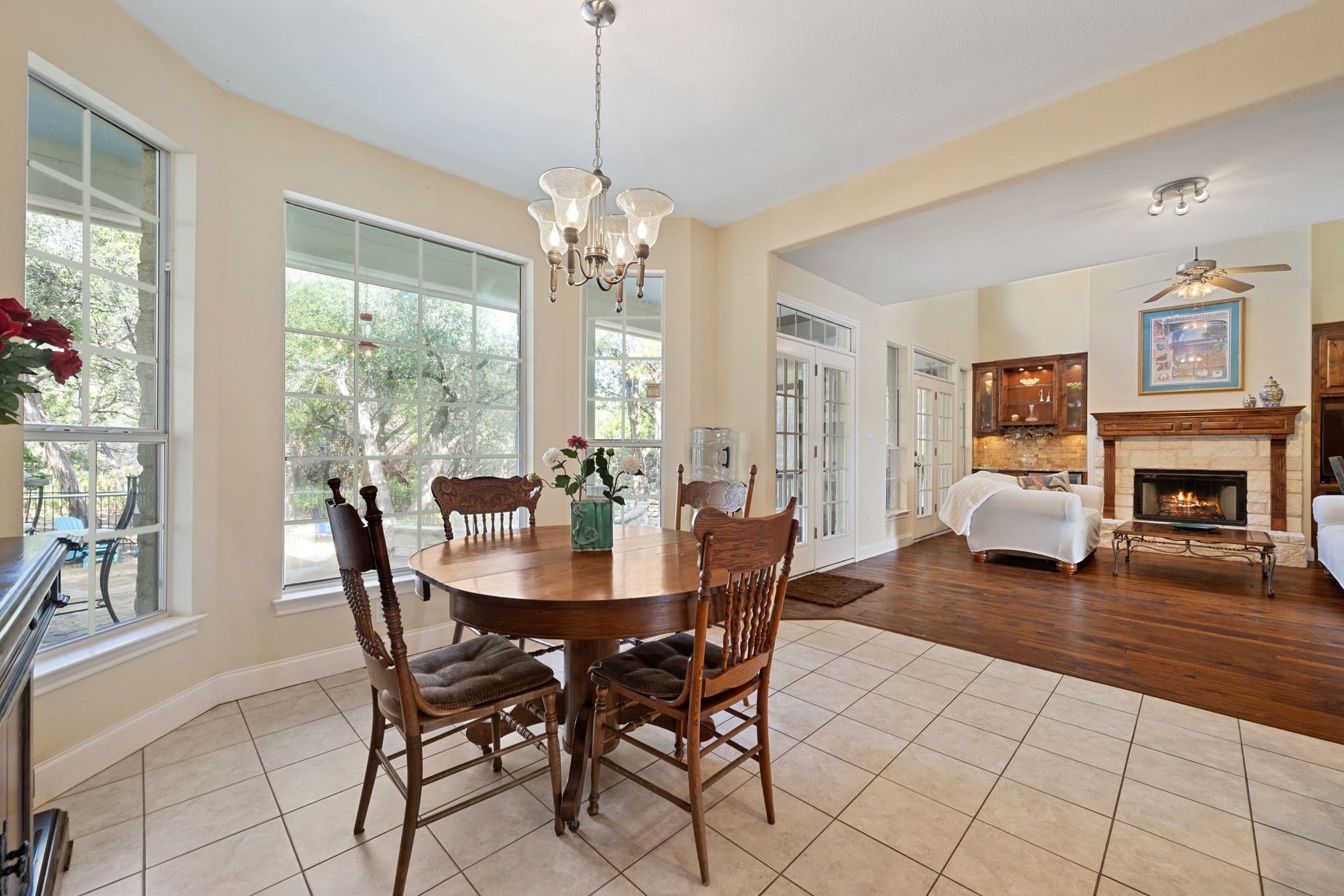 19045 Venture Drive Lago Vista, TX 78645 - Photo 11 of 40 Dining room with light tile patterned floors and a chandelier.