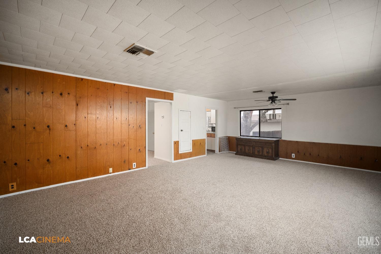 Undisclosed Address Taft, CA 93268 - Photo 11 of 28 an empty room with chandelier fan and windows