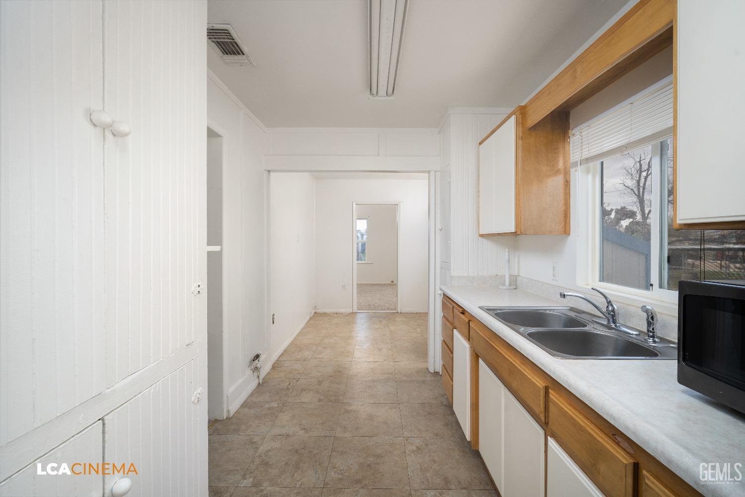 Undisclosed Address Taft, CA 93268 - Photo 12 of 28 a kitchen with a sink and a refrigerator