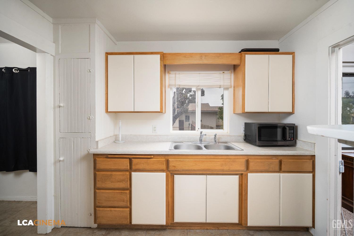Undisclosed Address Taft, CA 93268 - Photo 13 of 28 a kitchen with a sink cabinets and a window