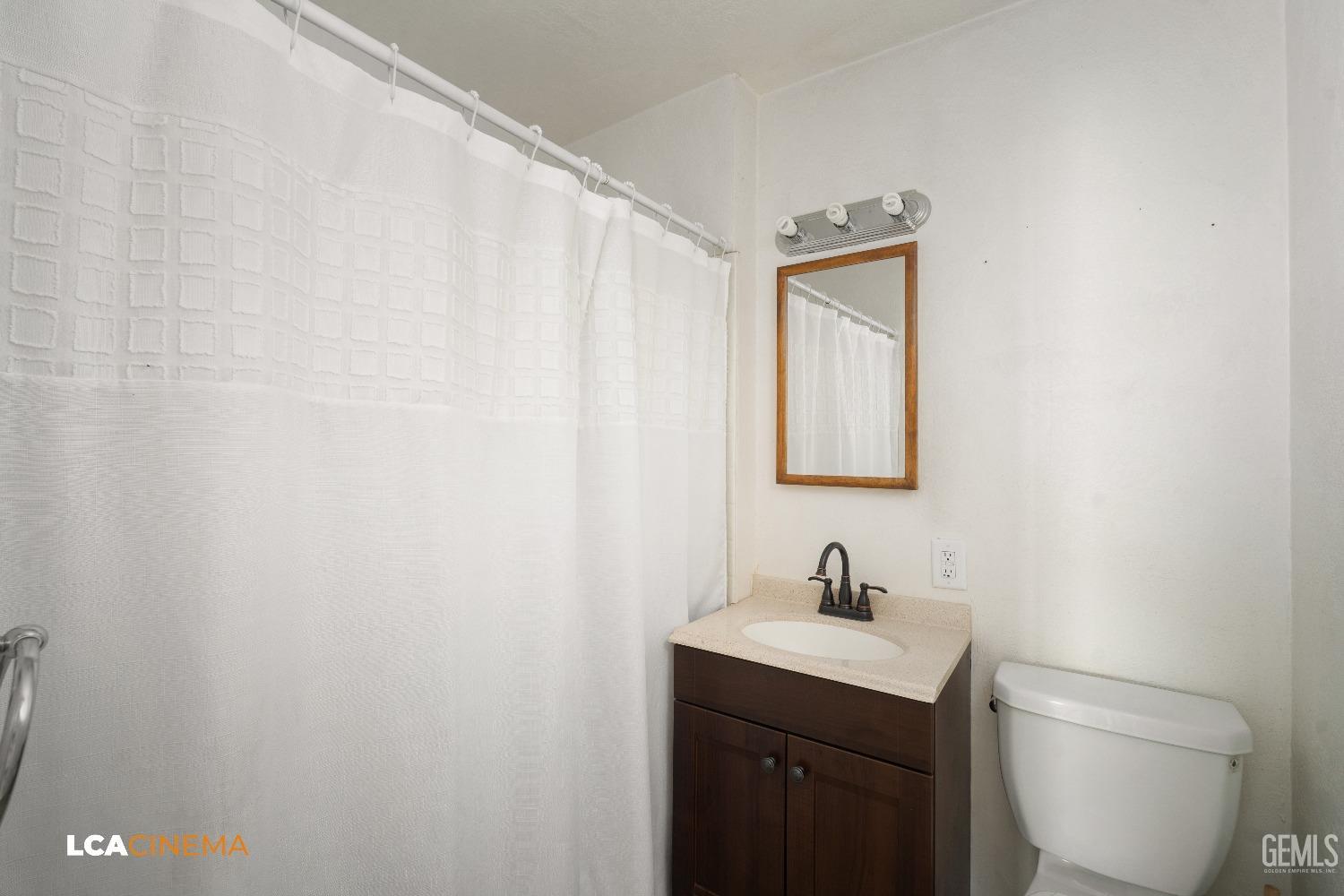 Undisclosed Address Taft, CA 93268 - Photo 16 of 28 a bathroom with a sink a toilet and mirror
