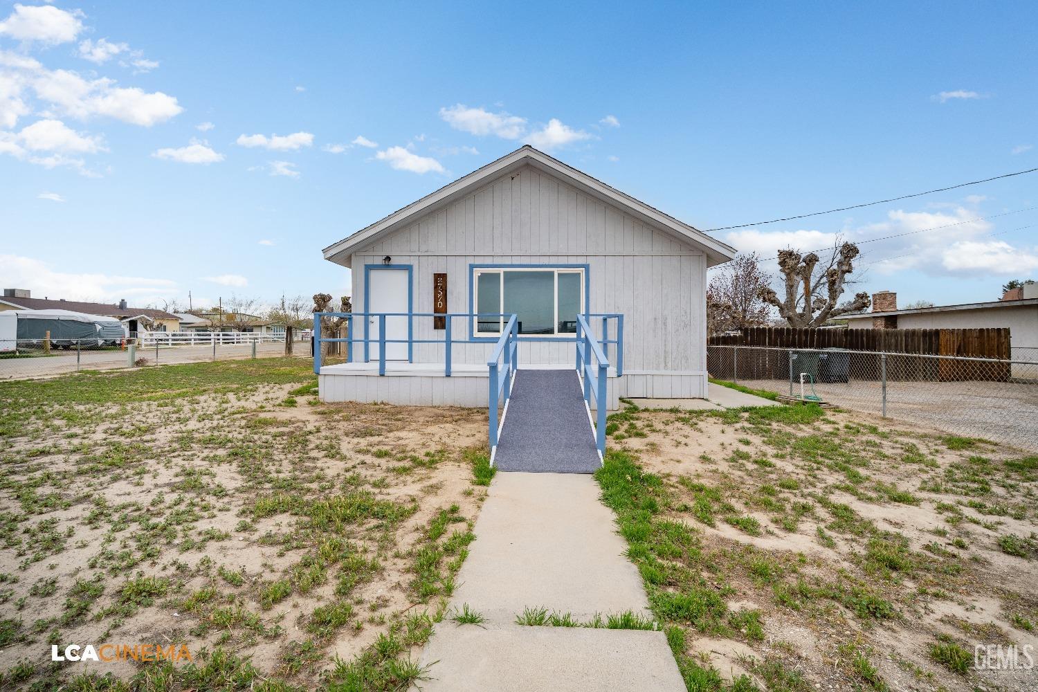Undisclosed Address Taft, CA 93268 - Photo 2 of 28 a front view of a house with garden