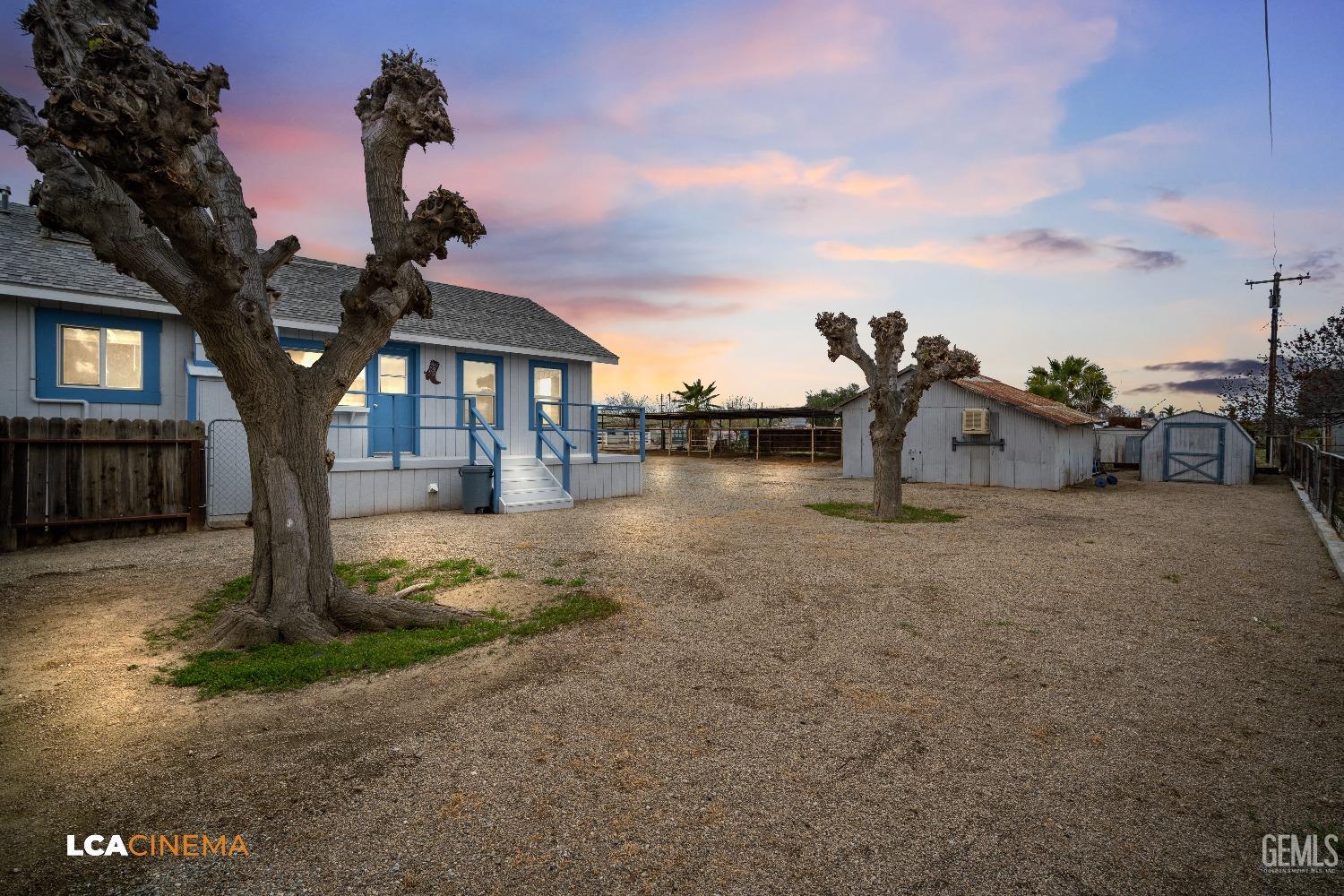 Undisclosed Address Taft, CA 93268 - Photo 7 of 28 a front view of a house with a yard and garage