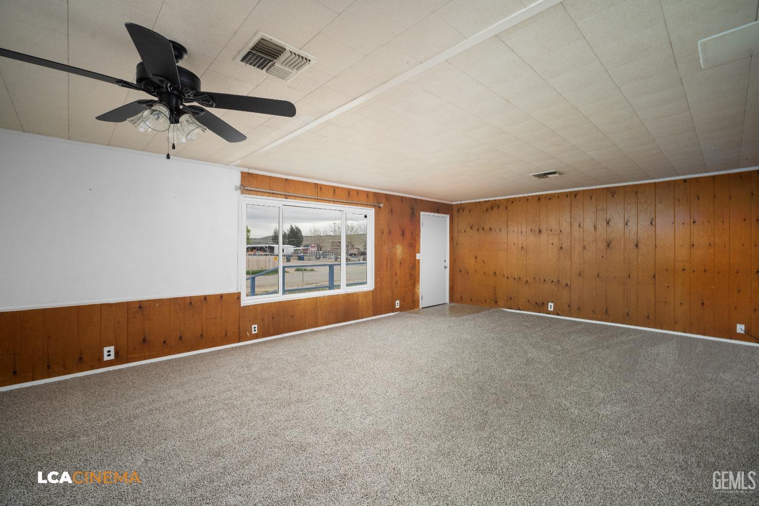 Undisclosed Address Taft, CA 93268 - Photo 10 of 28 an empty room with a ceiling fan and window