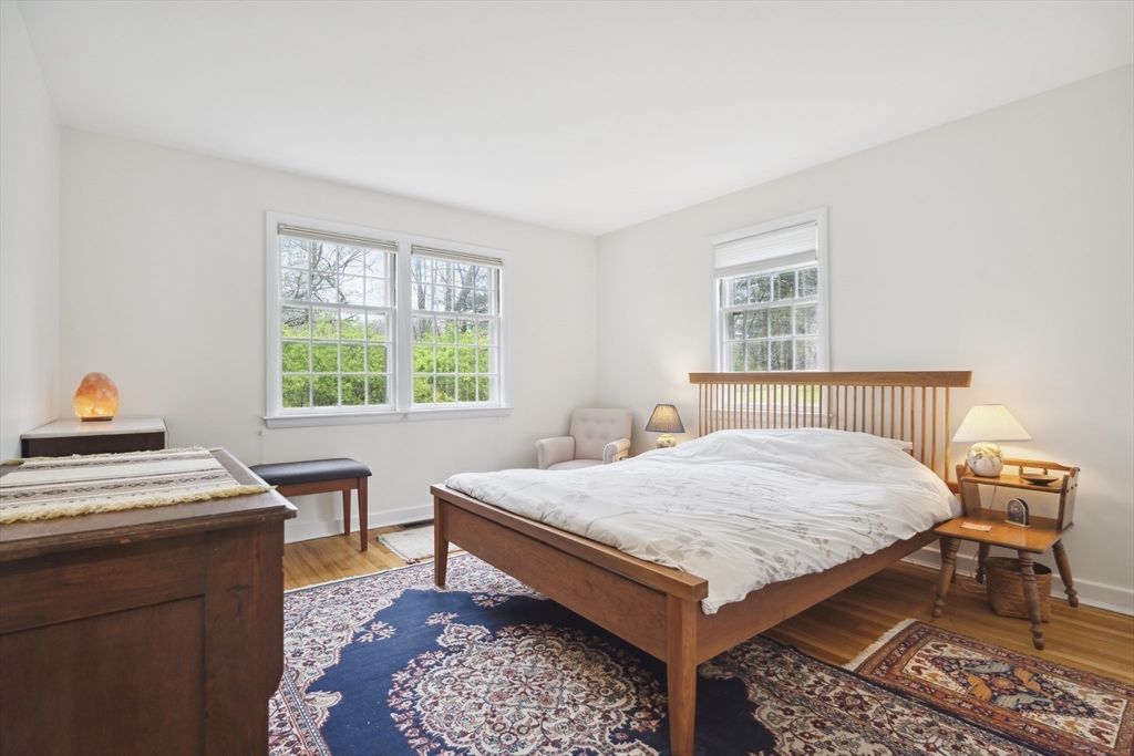 64 Trapelo Road Lincoln, MA 01773 - Photo 14 of 33 a bedroom with a bed and a table in it