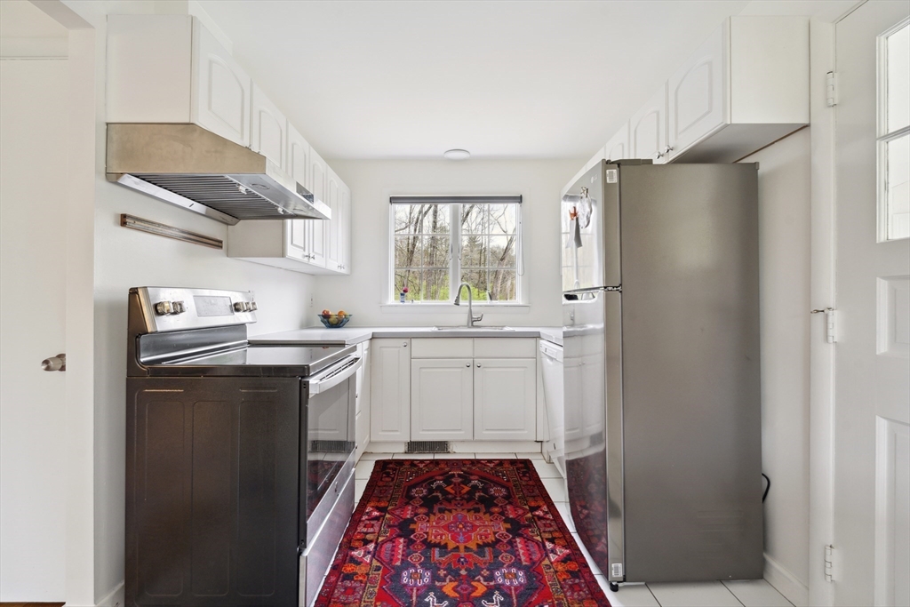 64 Trapelo Road Lincoln, MA 01773 - Photo 19 of 33 a kitchen with a sink a refrigerator and window
