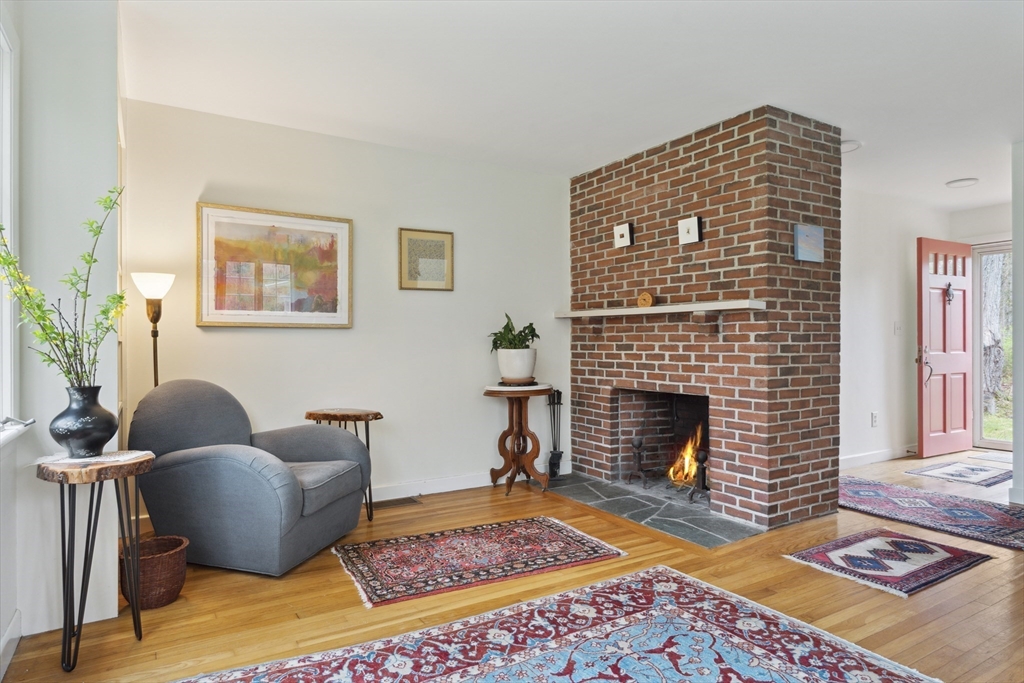 64 Trapelo Road Lincoln, MA 01773 - Photo 8 of 33 a living room with furniture rug and a fireplace