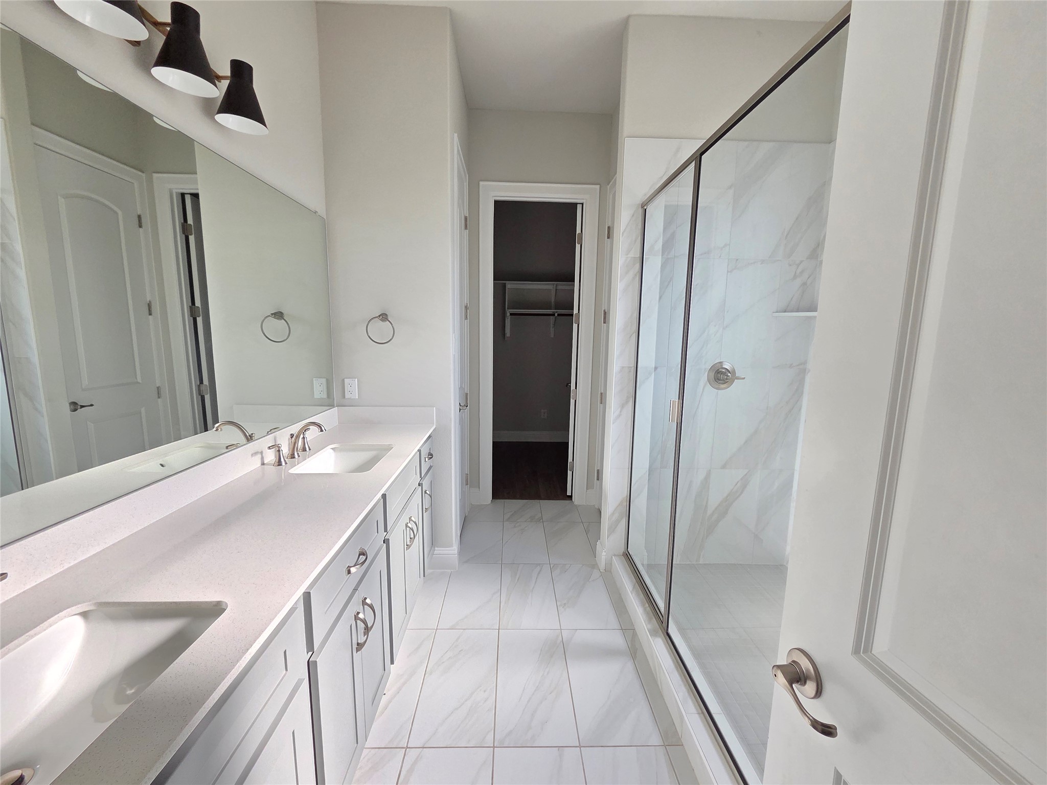 600 C-Bar Ranch Trail, Unit 121 Cedar Park, TX 78613 - Photo 18 of 32 Dual vanity sinks complement a spacious walk-in shower in this well-appointed bathroom.