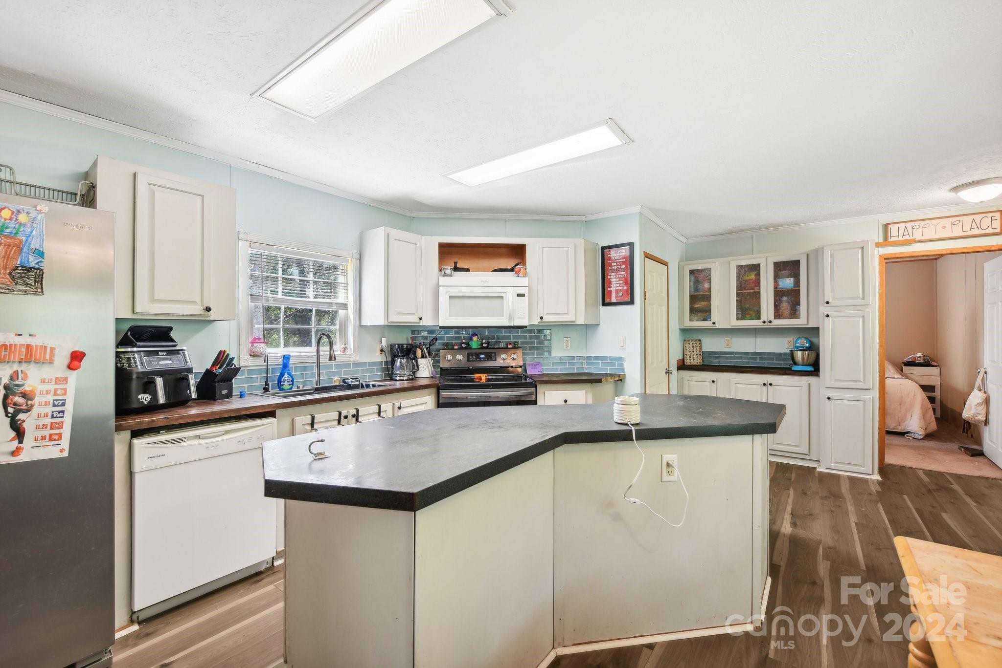 220 Yarbro Road Kings Mountain, NC 28086 - Photo 21 of 38 a kitchen with stainless steel appliances granite countertop a refrigerator sink stove and white cabinets