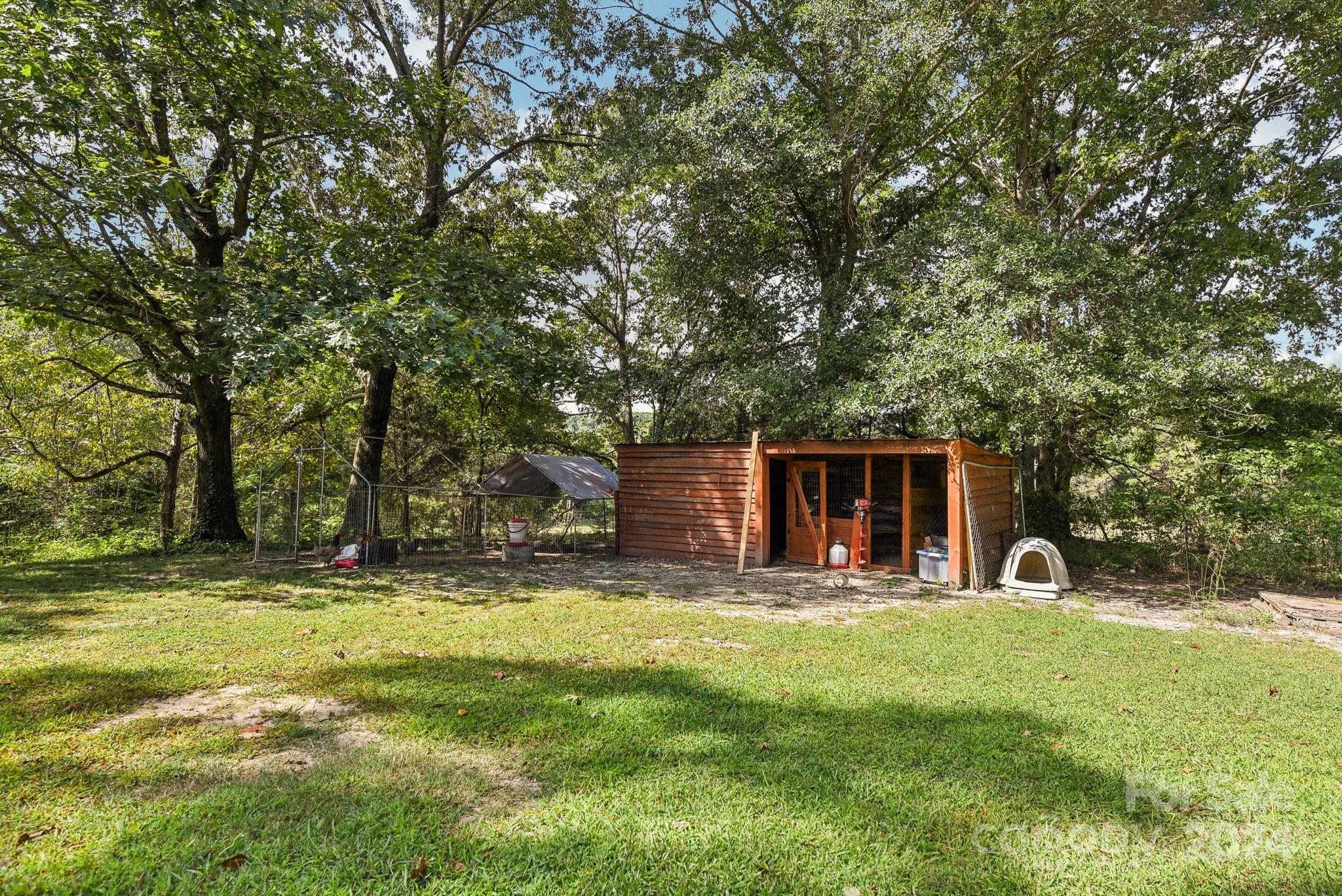 220 Yarbro Road Kings Mountain, NC 28086 - Photo 5 of 38 a view of a backyard with table and chairs and a large tree
