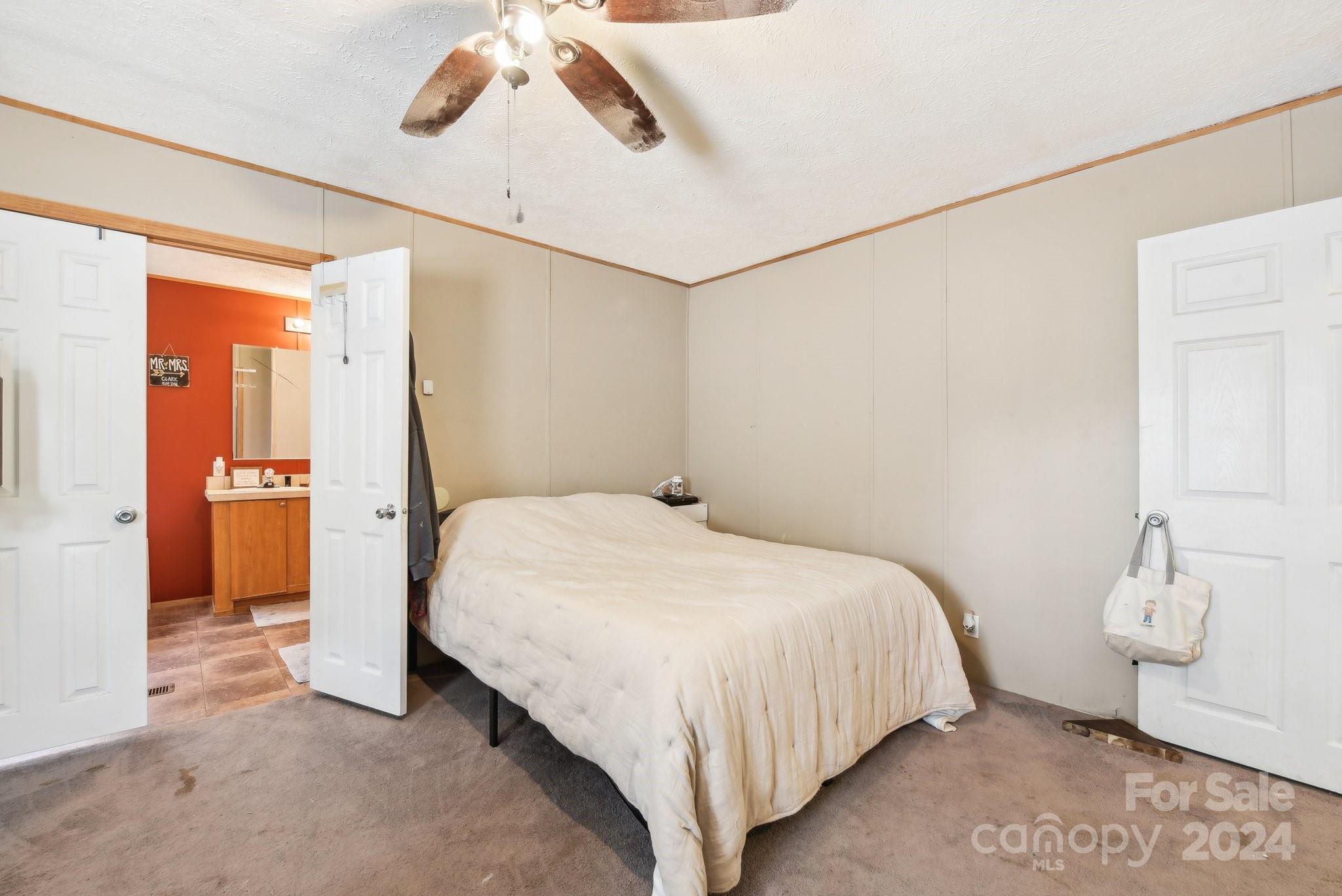 220 Yarbro Road Kings Mountain, NC 28086 - Photo 9 of 38 a bedroom with a bed and a chandelier