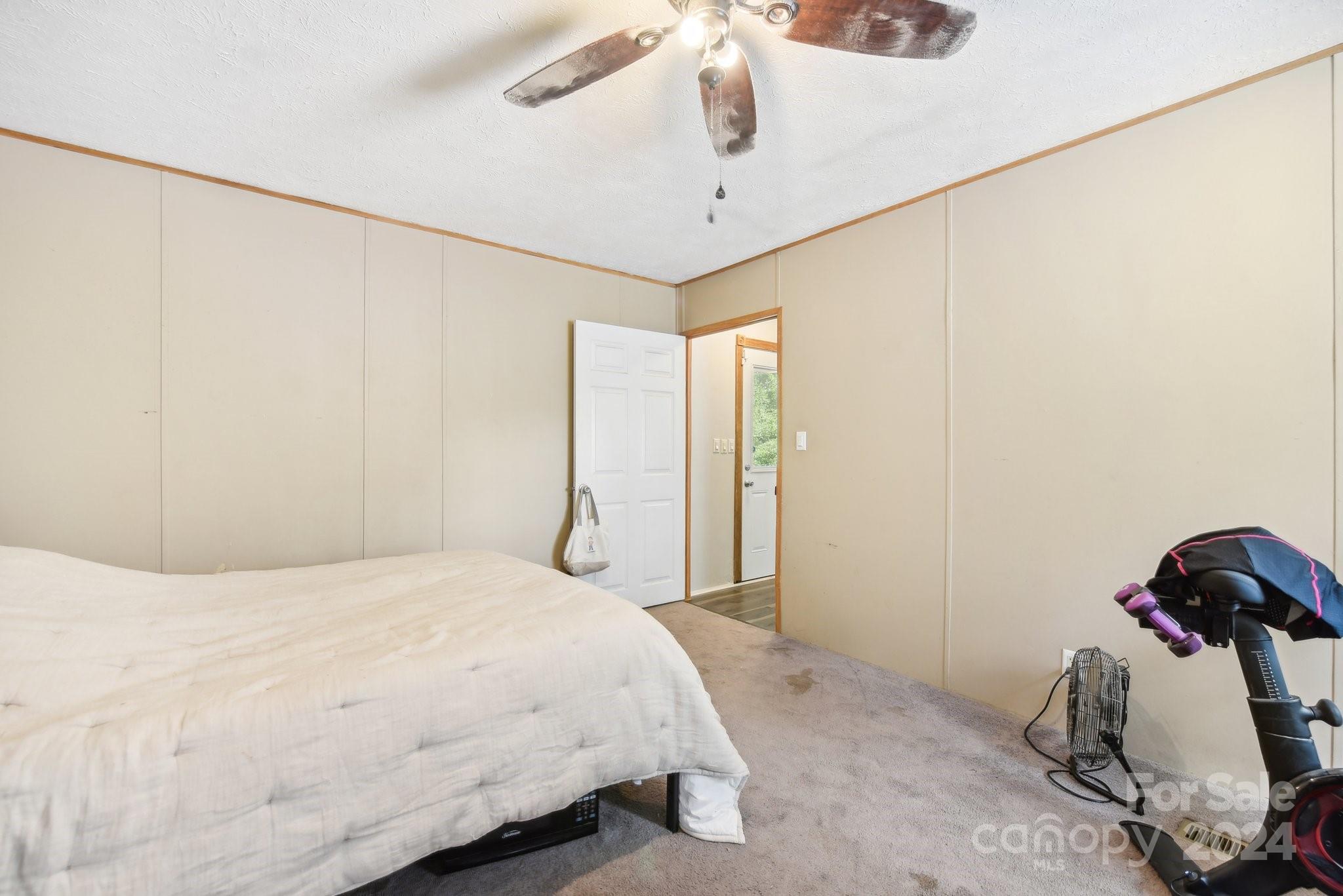 220 Yarbro Road Kings Mountain, NC 28086 - Photo 10 of 38 a bedroom with a bed and a chandelier
