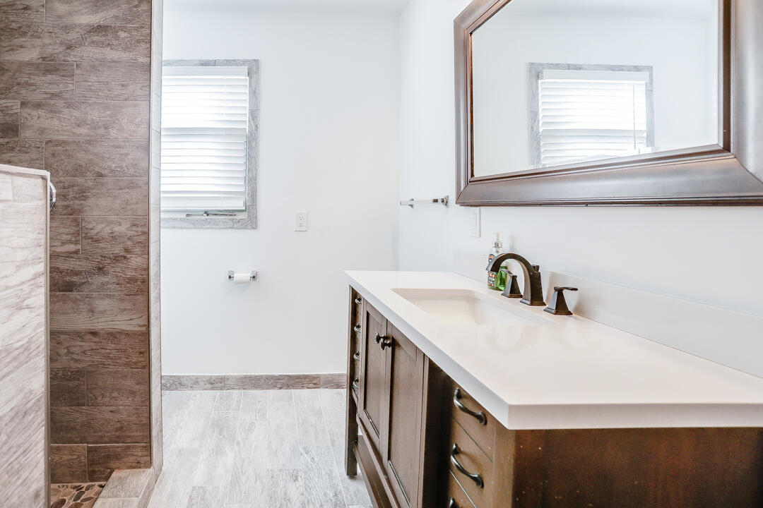 2123 66th Street Lubbock, TX 79412 - Photo 14 of 16 a kitchen with a sink cabinets and a window