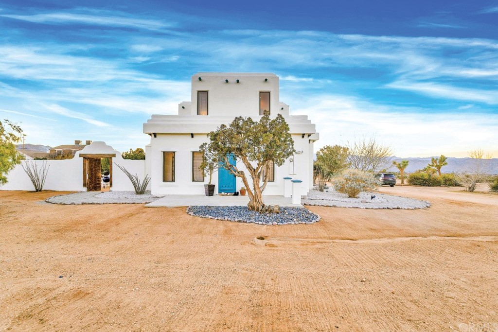 8426 Paradise View Road Yucca Valley, CA 92284 - Photo 1 of 1 a front view of a house with a yard